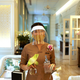 A waitress wearing a protective mask and face shield reacts at the Mandarin Oriental hotel, after the government eased some protective measures following the coronavirus disease (COVID-19) outbreak, in Bangkok, Thailand July 7, 2020. REUTERS/Jorge Silva